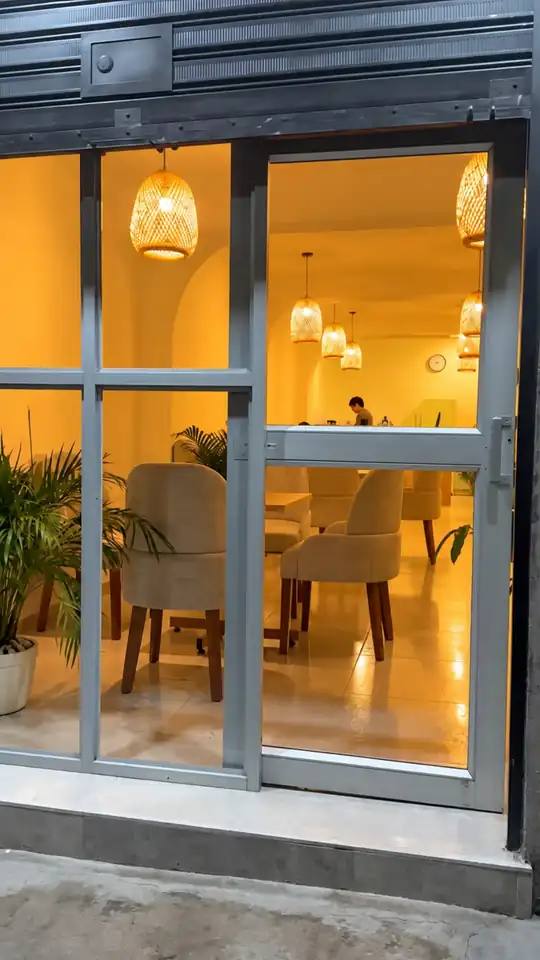 Recorrido real desde la fachada de vidrio, por el salón, hasta una mesa servida con café, latte y cookies